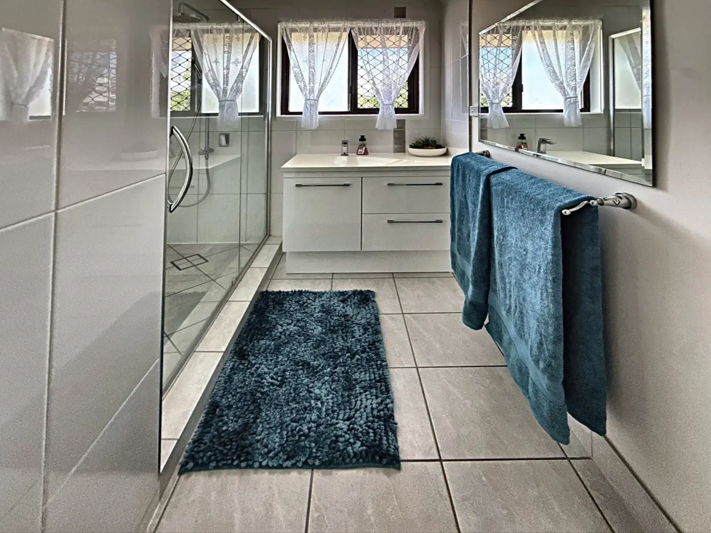Bathroom with frameless glass shower