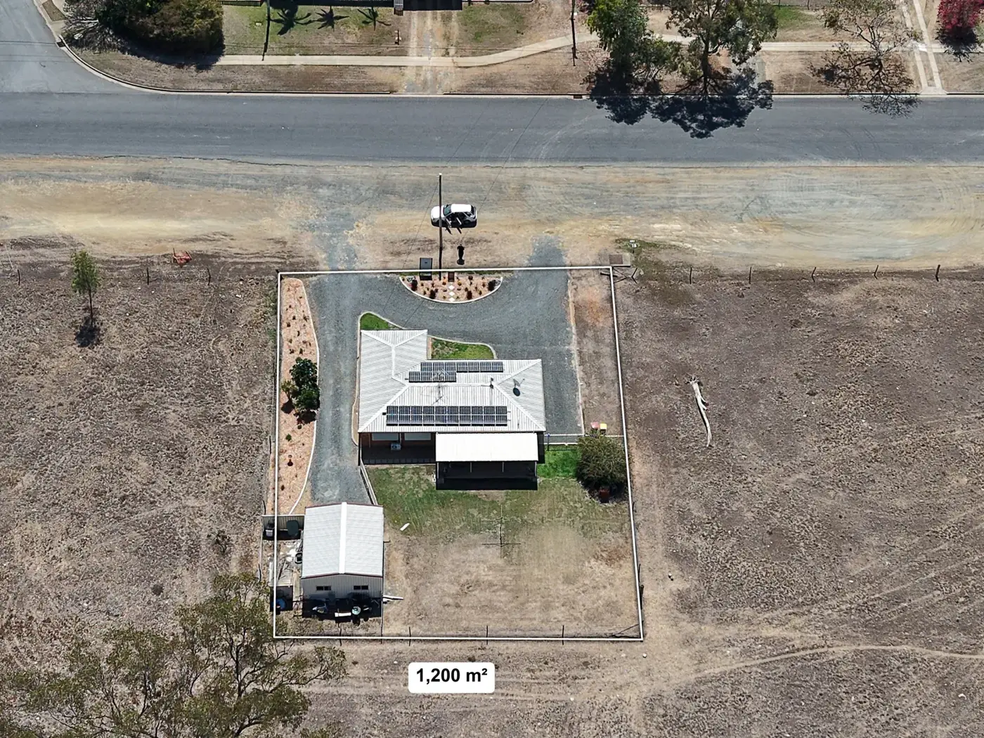 Top-down drone photo with the 1,200 square metre boundary marked